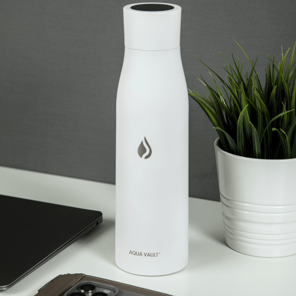 Glacier White AQUA VAULT PureX water bottle resting on a desk.