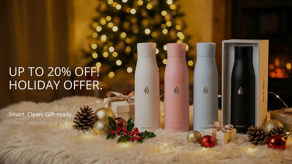 Four AQUA VAULT PureX Self-cleaning Smart Water Bottles with a decorative background featuring Christmas elements and a holiday sale offer.