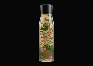 Bottle with microorganism models on a black background