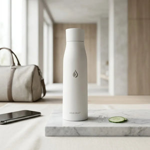 White AQUA VAULT PureX UV-C Self-Cleaning Smart Water Bottle on a marble surface with a blurred background