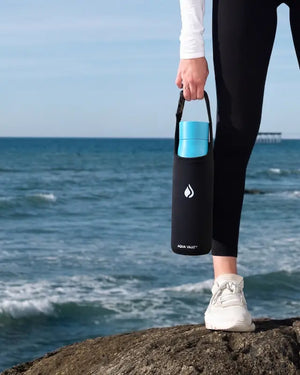 AQUA VAULT PureX UV-C self-cleaning smart water bottle hold by a woman.