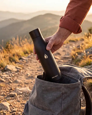 AQUA VAULT PureX UV-C self-cleaning smart water bottle held by person.
